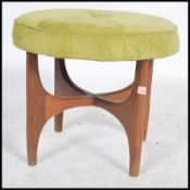 A 1970's G-Plan teak wood dressing table stool of circular form being raised on teak atomic style