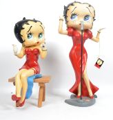 A large vintage Betty Boop figurine featuring the iconic character in a red dress singing to a