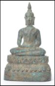 A 19th century Oriental bronze figure of a Buddha moulded in the lotus position raised on a pedestal