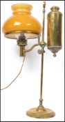 An early 20th century Argand and Co brass coaching  lamp complete with orange glass shade. Measures: