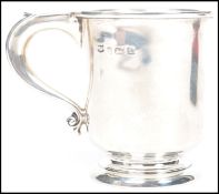 A 20th century silver hallmarked christening cup tankard of plain form raised on a circular foot