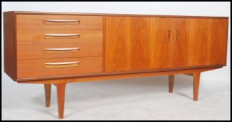 A good mid century Danish manner sideboard - dresser being raised on tapering legs with a series