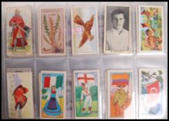 Cigarette / Trading Cards: An album of assorted vintage trading cards, all odd cards / part sets.