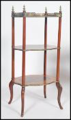 A 19th century walnut three tier etagere raised on splayed feet with ormolu gallery and edges with