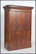 An early 19th century flame mahogany secretaire abattant having a fold out front desk with a