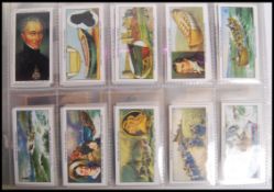 Cigarette Cards: An album of assorted vintage cigarette and trading cards - all odd cards or part