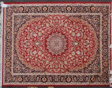 A large Iranian / Persian Keshan carpet - rug having red  ground with geometric decoration and