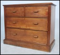 An early 20th century 1920's oak square fronted walnut cottage chest of two short over three long