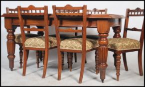 A Victorian mahogany dining table raised on reeded legs with fitted frieze frame having a solid