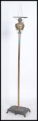 A late Victorian brass floor standing oil / standa