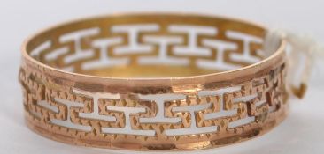 A 14ct gold band ring with pierced Greek Key decoration.  Weight 0.9g. Size N.5. Marked 585. Tests