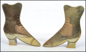 A pair of 20th century brass novelty firesides in the form of Victorian boots. Measures: 10cm high x