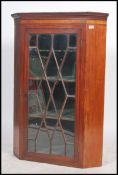 A Georgian early 19th century mahogany inlaid large hanging corner cabinet with single astragal