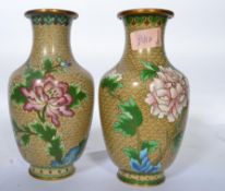 A pair of 20th century Chinese Cloisonne enamel matching vases decorated with peaches, peonies and