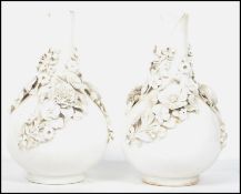 A pair of possible 19th century Stevenson and Hancock Derby Blanc de Chine vases, encrusted with