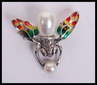 A sterling silver Plique a Jour brooch in the form of a fire fly, weighs 3 grams.