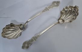 A pair of American silver 13/16 purity serving spoons with shaped and scrolled handles, curved
