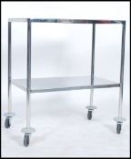 A vintage 20th century retro industrial medical dentist trolley of chrome construction raised on