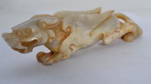 An Oriental jade dragon carving, hand carved with raised wings and open jaw. Weighs 248 grams.