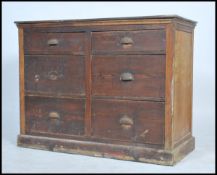 A 1930s/40s haberdashery 6 drawer oak chest of drawers having four deep drawers, with a show wood