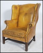 A good shaped Antique revival mustard yellow leather chesterfield armchair with studded details