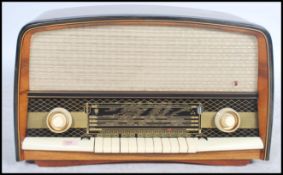 A large mid century walnut lacquered valve radio of lozenge by Orion Imp. The large case with