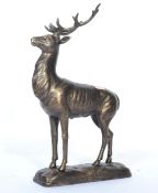 A vintage 20th century cast iron figurine of a adult reindeer with detailed features raised on a