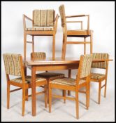 A good mid century Gordon Russell solid golden oak draw leaf square refectory dining table