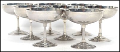 A set of eight stainless steel Art Deco French Champagne glasses raised on stepped circular foot