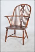 An 18th / 19th Century elm and yew Windsor farmhouse elbow chair. The arched stick back with a