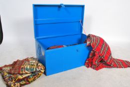 A collection of vintage woolen picnic blankets different in colours and all contained within atin