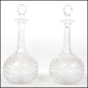 A pair of 19th century cut glass decanters having bulbous bodies with hand engraved decoration,