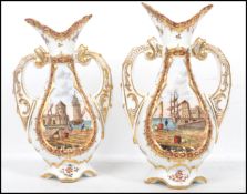 A pair of 19th century Dresden twin handled ceramic vases having a white ground with painted