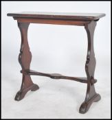 An early 20th century ecclesiastical pugin manner oak side table being peg jointed with shaped