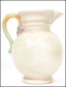 A Clarice Cliff large early 20th century jug with floral vine and spray handle in the ' My