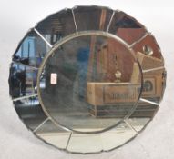 A vintage large Art Deco bevelled glass mirror of circular form having a central circular panel with