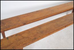 A pair of 19th century French refectory pig benches. Each with shaped single plant tops of pine