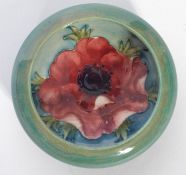 A 20th century Moorcroft ceramic bowl of short form having a turquoise green ground with painted and