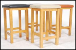 A set of four vinyl topped multi coloured stools i