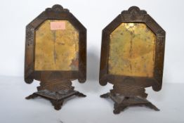 A pair of Art Deco cast iron cafe menu holders with adjustable backs, the frames decorated with