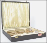 A stunning Art Deco silver hallmarked silver five piece dressing table set. The matching set