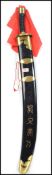 A 20th century Oriental decorative dress sword of large form having banded handle with brass bound