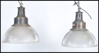 A pair of vintage 20th century Art Deco glass pendant shades light fixtures having brass fittings.