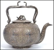 A vintage early 20th century silver white metal Persian / Islamic tea pot having an chased decorated
