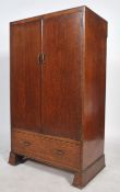 An early 20th century oak bachelors wardrobe combination having double doors being mid height with