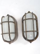 A pair of vintage 20th century retro industrial Italian Goccia bulk head lamps.