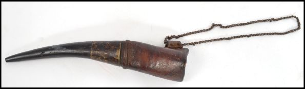 A 19th century horn gunpowder scoop of tapering form with metal collar and chain to top. Measures 18
