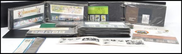 A large collection held within three albums of unused decimal stamps and first day covers along with