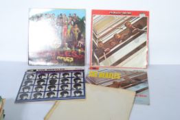 A group of five Beatles long play LP vinyl records to include Please Please Me, A Hard Day's