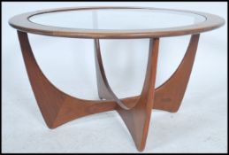 A 1970's retro G-Plan teak wood ' astro ' coffee table of circular form raised on shaped legs with
